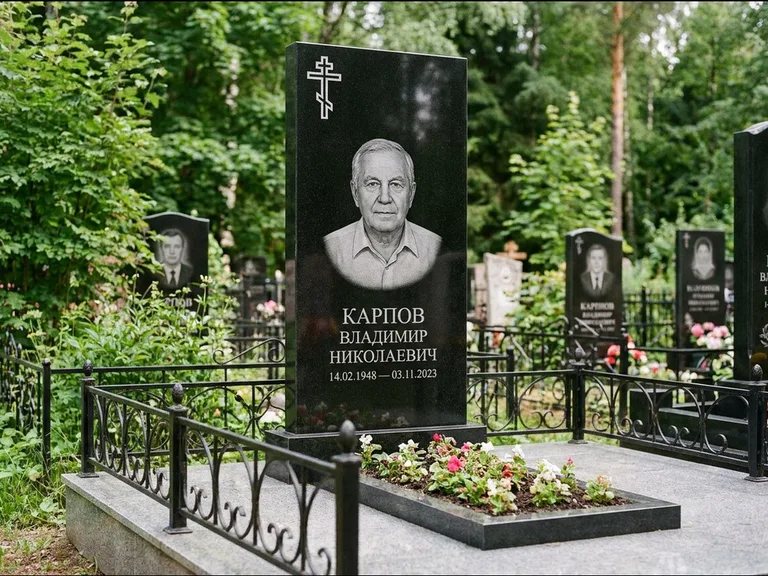 Памятник из чёрного гранита — узкая стела с ажурным крестом с православным восьмиконечным крестом, работа «Гущин» в Томске